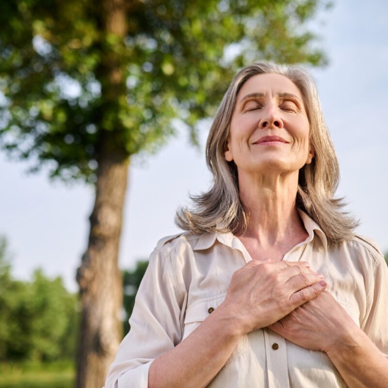 Femme senior se tenant les mains sur le buste