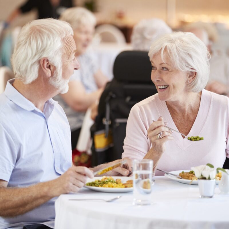 Couple senior partageant un repas dans un maison de retraite